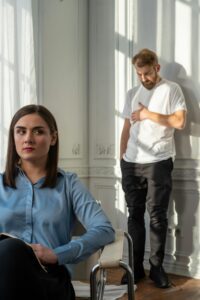 A woman and bearded man in an indoor counseling session, discussing emotional issues.