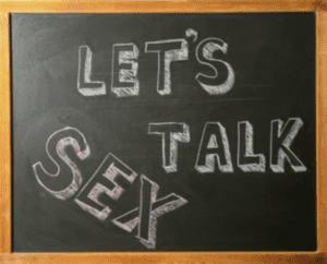 Chalkboard with the words “Let’s Talk Sex” written in chalk to represent conversations about intimacy in therapy.